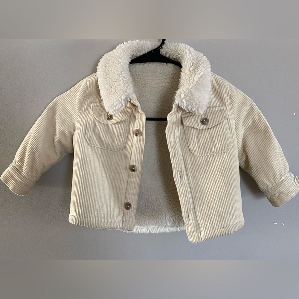 Kith toddler jacket size 12-18M. Beige color with fur on inside. Moderately worn